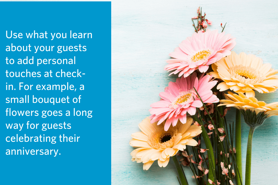 a bouquet of flowers lying on a wooden table with article quote to the left: Use what you learn about your guests to add personal touches at check-in. For example, a small bouquet of flowers goes a long way for guests celebrating their anniversary.