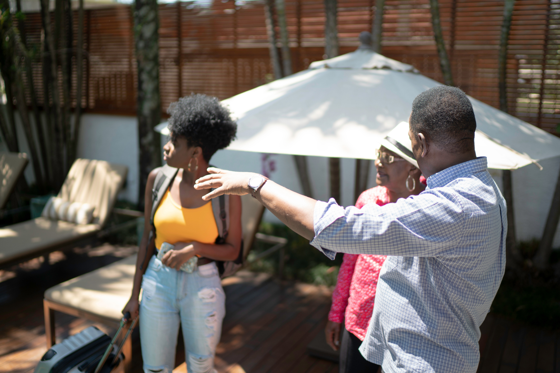 An older woman and younger lady being shown aroung a property by a man.