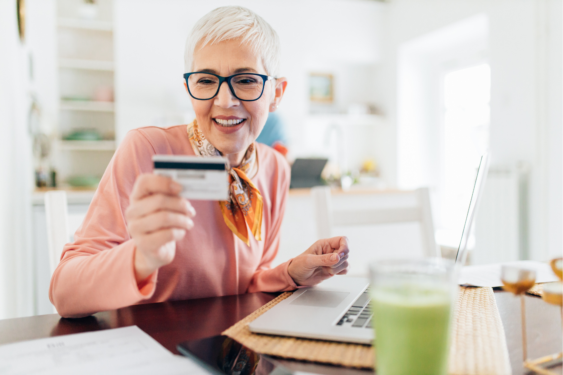 A woman entering credit card info on a laptop.